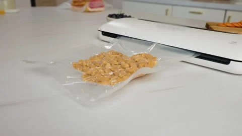 Vacuum Packaging Raw Peanuts to Maintain Freshness, Extend Shelf Life and Stock Footage 327319491