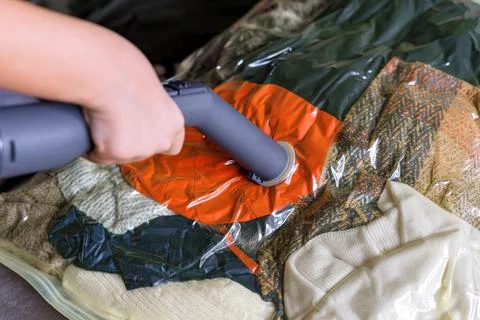 Vacuum packaging of things for storage and transportation.Compact plastic sealed Stock Photos