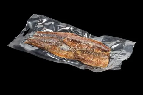 Vacuum packed bream on black Stock Photos