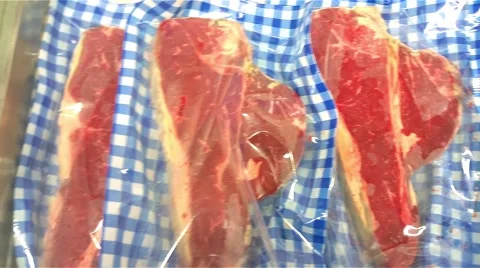 Vacuum packed I-bone steaks, at a meat market shop Stock Footage 56441736