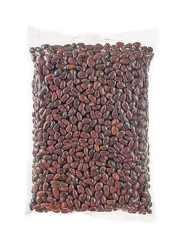 Vacuum packed pine nuts in shell. White background. Isolated. Stock Photos