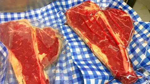 Vacuum packed T-bone steaks, at a restaurant meat market Stock Footage 56441690