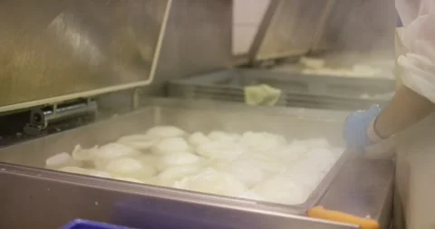 Vacuum packing machine sealing white food portions, Packaging Line Stock Footage 340045373
