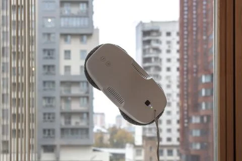 Vacuum robot washes window. Stock Photos