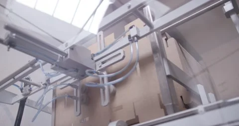 Vacuum suction arm picking flat cardboard blanks in packaging, Wide Shot 動画素材 340045192