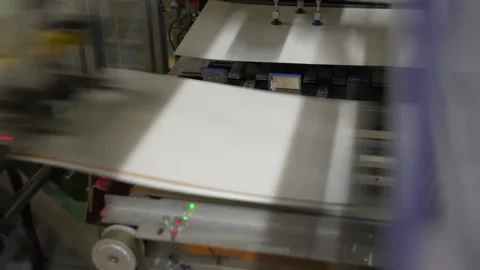 Vacuum suction cups lifting white paper board sheets from stack in automatic Stock Footage 347720486