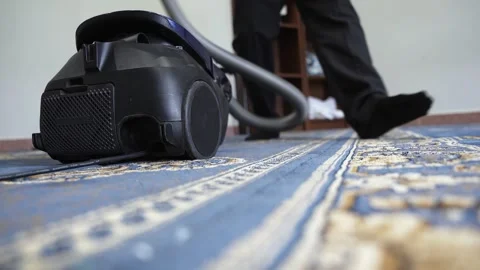 Vacuuming Blue Patterned Carpet Low Angle Shot Stock Footage 334778991