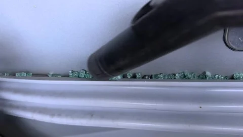 Vacuuming broken glass trapped inside the car Stock Footage 321481013