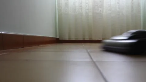 Vacuuming the floor with curtains in the back ground Stock Footage 330774437