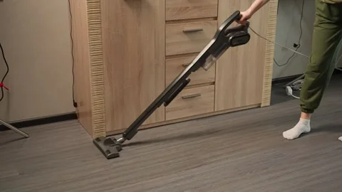 Vacuuming the floor to remove dust Видео 306689363