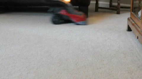 Vacuuming a room with red vacuum cleaner Stock Footage