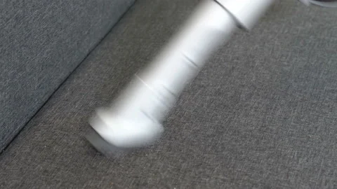 Vacuuming the sofa in the room Video stock 115374065