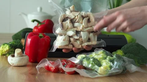 The vacuumization process. Sliced champignons, mushrooms in vacuum packaging for Stock Footage 303696829