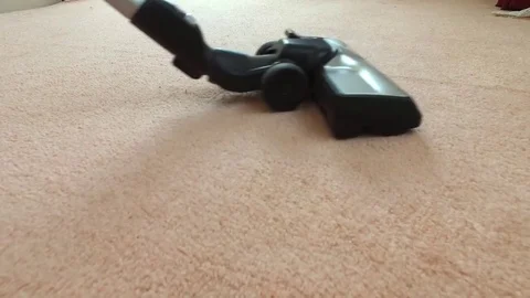 Vacuums the carpet. Stock Footage 78990757