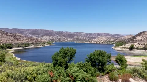 Vail Lake Framed by Shrubs, Trees and Rugged Dry Hills Stock Footage 346382880