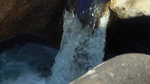 Vale da Lua waterfall flowing through sculpted quartzite formations along the Stock Footage 346568466