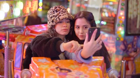 Valencia funfair - two friends take selfie pictures with smartphones Stock Footage 170827735