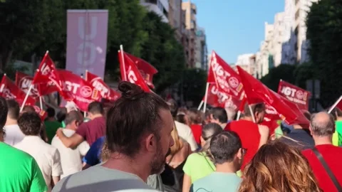 VALENCIA, SPAIN - 2026/09/12: Close crowd raises union flags overhead in. Stock Footage 345450592