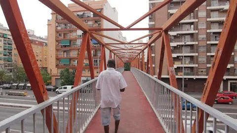 Valencia, Spain - August 7 2018: Man crossing pedestrian bridge in Valencia. Stock-Footage 93518097