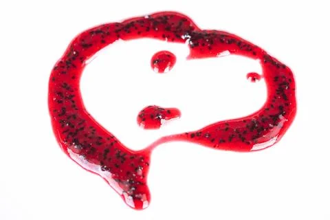 Valentine berry spread. Glossy red seedfilled berry sauce with delicate drizzle. 库存照片