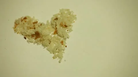 Valentine Bread-Crumbs Heart Blows Away Stock Footage