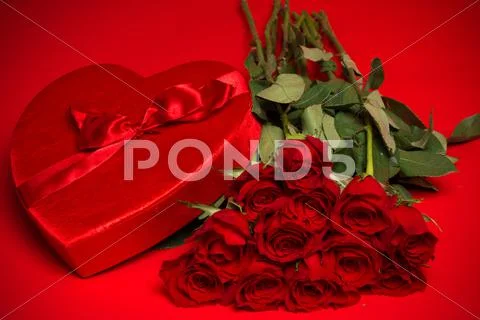 Valentine Candy Box and Roses on Red Background Stock Photos