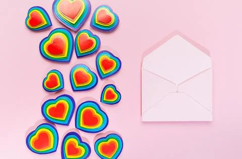 Valentine day background with open blank envelope as love note and rainbow he Stock Photos