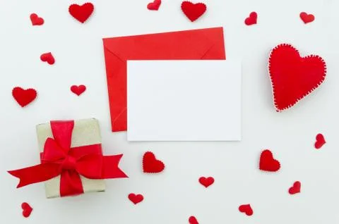 Valentine day composition: gift box with ribbon and red felt hearts, photo Stock Photos