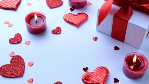 Valentine day composition: red love hearts, romantic gift box, candle on white Stock Footage 146749631