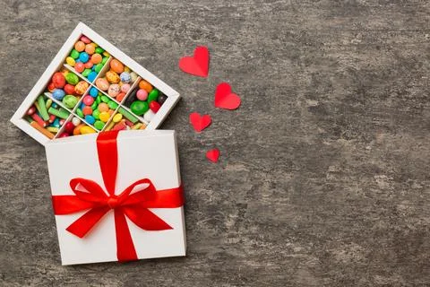 Valentine day composition: sweet candy, with gift boxes with bow and red fe.. Stock Photos