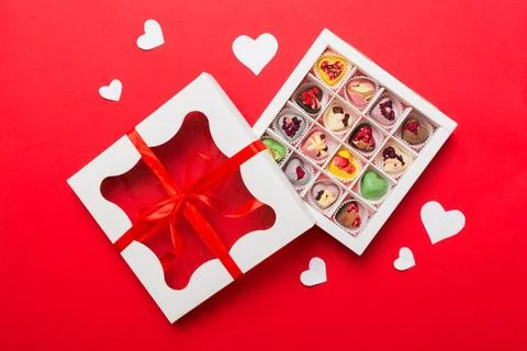 Valentine day composition: sweet candy, with gift boxes with bow and red fe.. Stock Photos