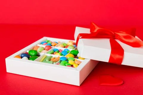 Valentine day composition: sweet candy, with gift boxes with bow and red fe.. Stock Photos