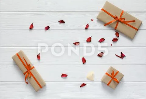 Valentine Day Concept decorated Gift Boxes white Wood Flower Petals Stock Photos