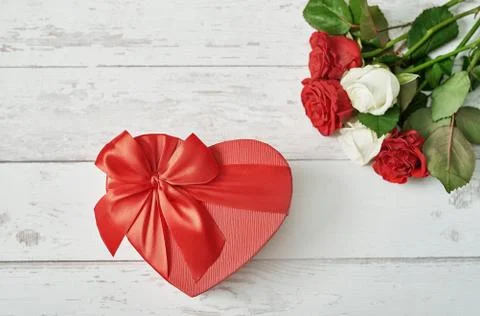 Valentine day romantic background with red roses and gift box. Happy Valentin Stock Photos
