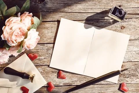 Valentine day theme. Top view of love letter, ink and fountain pen, roses a.. Stock Photos