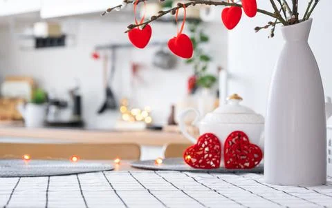 Valentine decor on table of white kitchen in cozy home. Copy space. Gift fo.. Stock Photos
