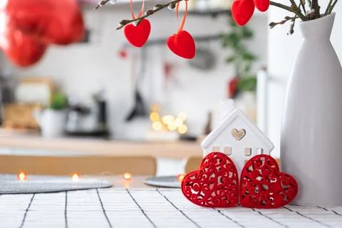 Valentine decor on table of white kitchen in cozy home. Copy space. Gift fo.. Stockfoto's