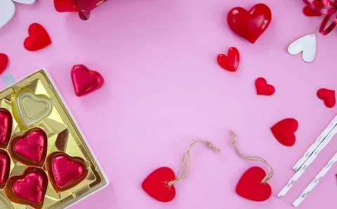 Valentine hearts with string and chocolates on pink background Stock Photos