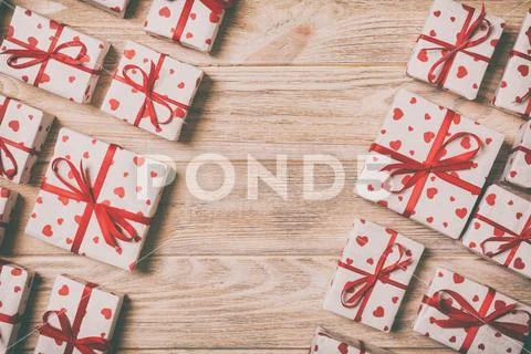 Valentine or other holidays concept. Lots of Gift boxes on wood background to Stock Photos