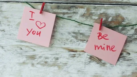 Valentine's cards with red clips on rustic wood background, 4k dolly shot Video stock 71361893
