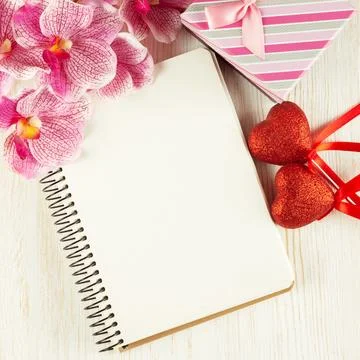 Valentines Day background with empty notepad for text, giftbox, pink orchid.. Stock Photos