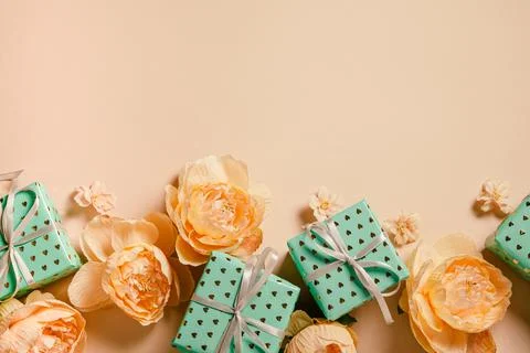 Valentine's Day background. Gift boxes with ribbons and roses on peach backgr Stock Photos