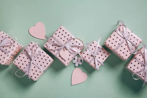 Valentine's Day background. Gift boxes with ribbons and hearts on blue backgr Stock Photos