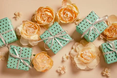 Valentine's Day background. Gift boxes with ribbons and roses on peach backgr Фото