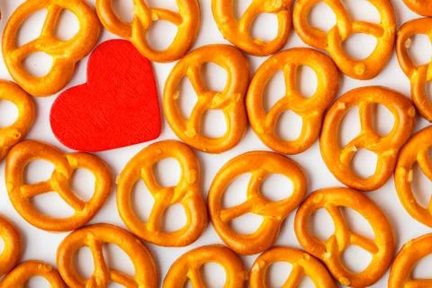 Valentine's day background pretzels pattern and red heart. 스톡 사진