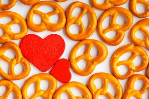 Valentine's day background pretzels pattern and red heart. 스톡 사진