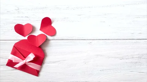 Valentines day background with red envelope. Love hearts on wooden background Stock Footage 164210047