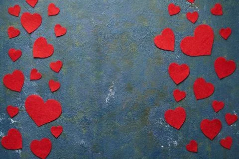 Valentines day background with red woolen hearts on blue concrete creative. Copy Stock Photos