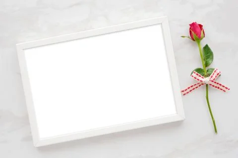 Valentine's day background, template, Red rose and blank white wooden frame o Stock Photos