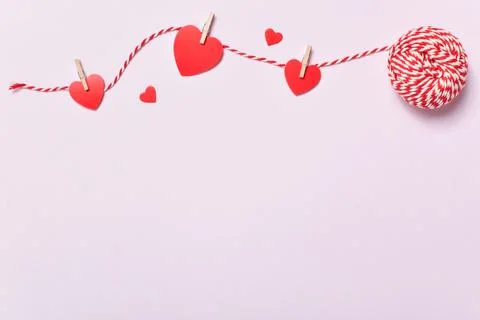 Valentine's Day background with thread and hearts. Copy space. Stock Photos